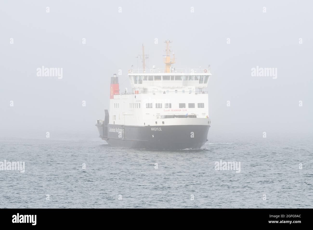 ferry sailing in fog - CalMac (Caledonian MacBrayne) MV Argyle ferry arriving at Wemyss Bay from Rothesay, Isle of Bute in fog - Scotland, UK Stock Photo