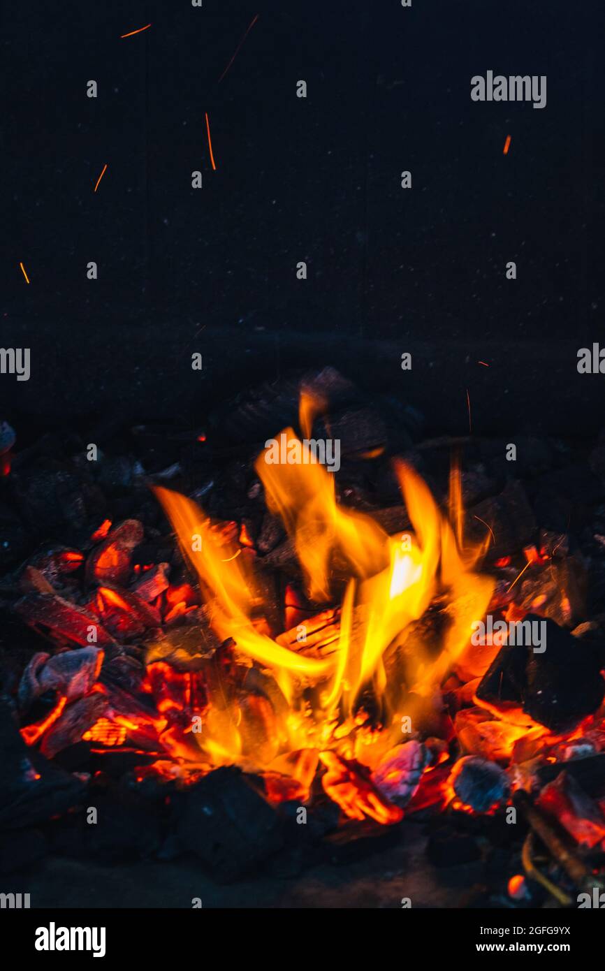 detail of the fire and embers lit on a barbecue waiting for the charcoal to burn out concept summer food Stock Photo
