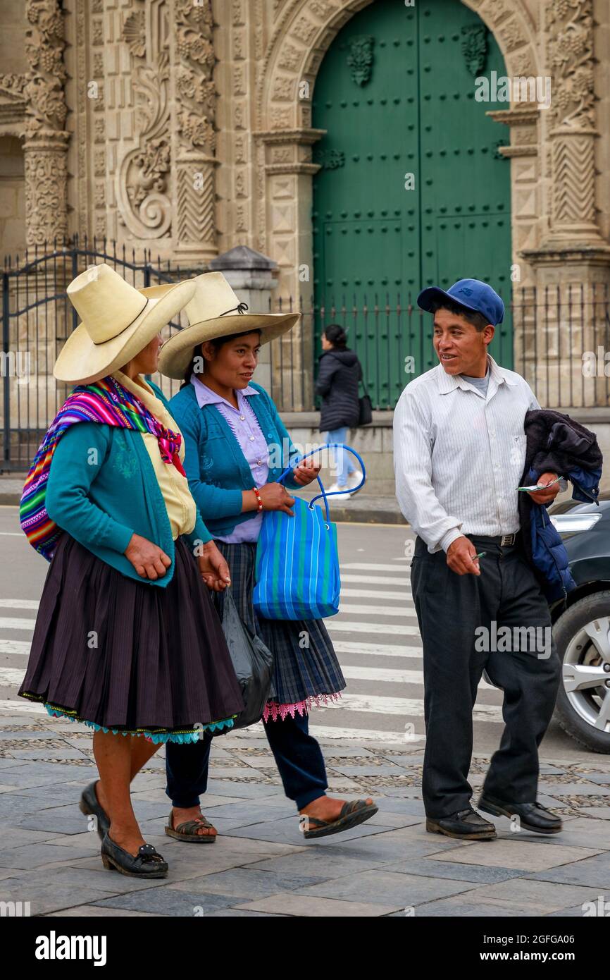 Cajamarca, Cajamarca/Peru - 16.12.2019: Peruvian locals walking on the sidewalk in front of the main city cathedral Stock Photo