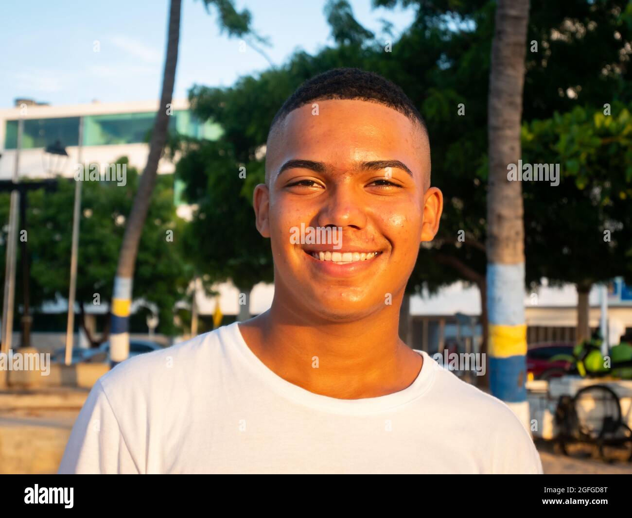 Riohacha, La Guajira, Colombia - May 26 2021: Portrait of a Young Latin Man Smiling at the Camera in the Public Park in the Sunset Stock Photo