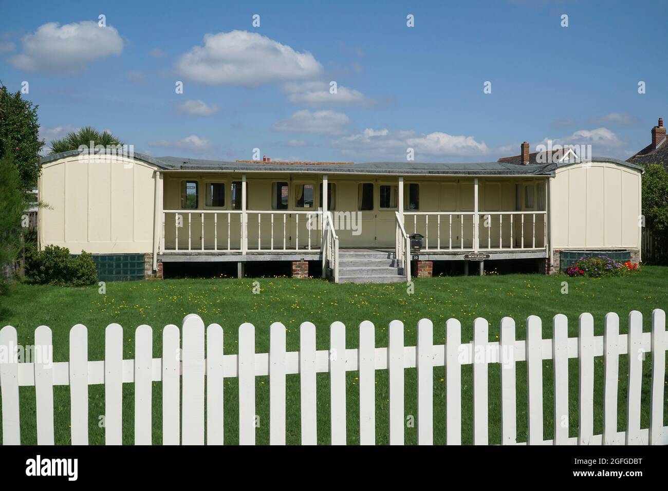 East Wittering, UK, 25 August 2021: In the West Sussex village of East Wittering several homes have been built around disused railway carriages. This Stock Photo