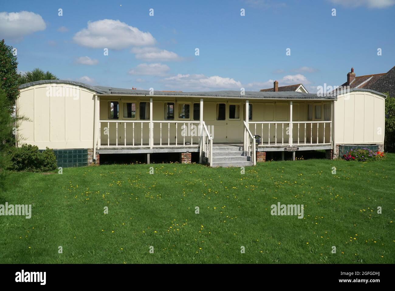 East Wittering, UK, 25 August 2021: In the West Sussex village of East Wittering several homes have been built around disused railway carriages. This Stock Photo