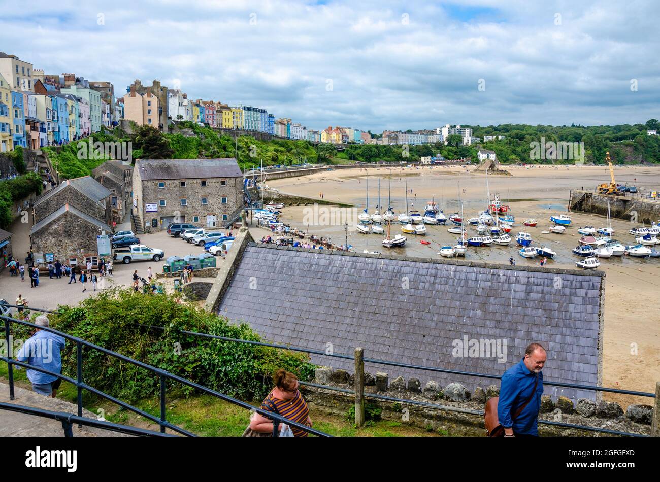A view looking across Tenby Harbour towards and the north beach with colourful houses on the side. Stock Photo