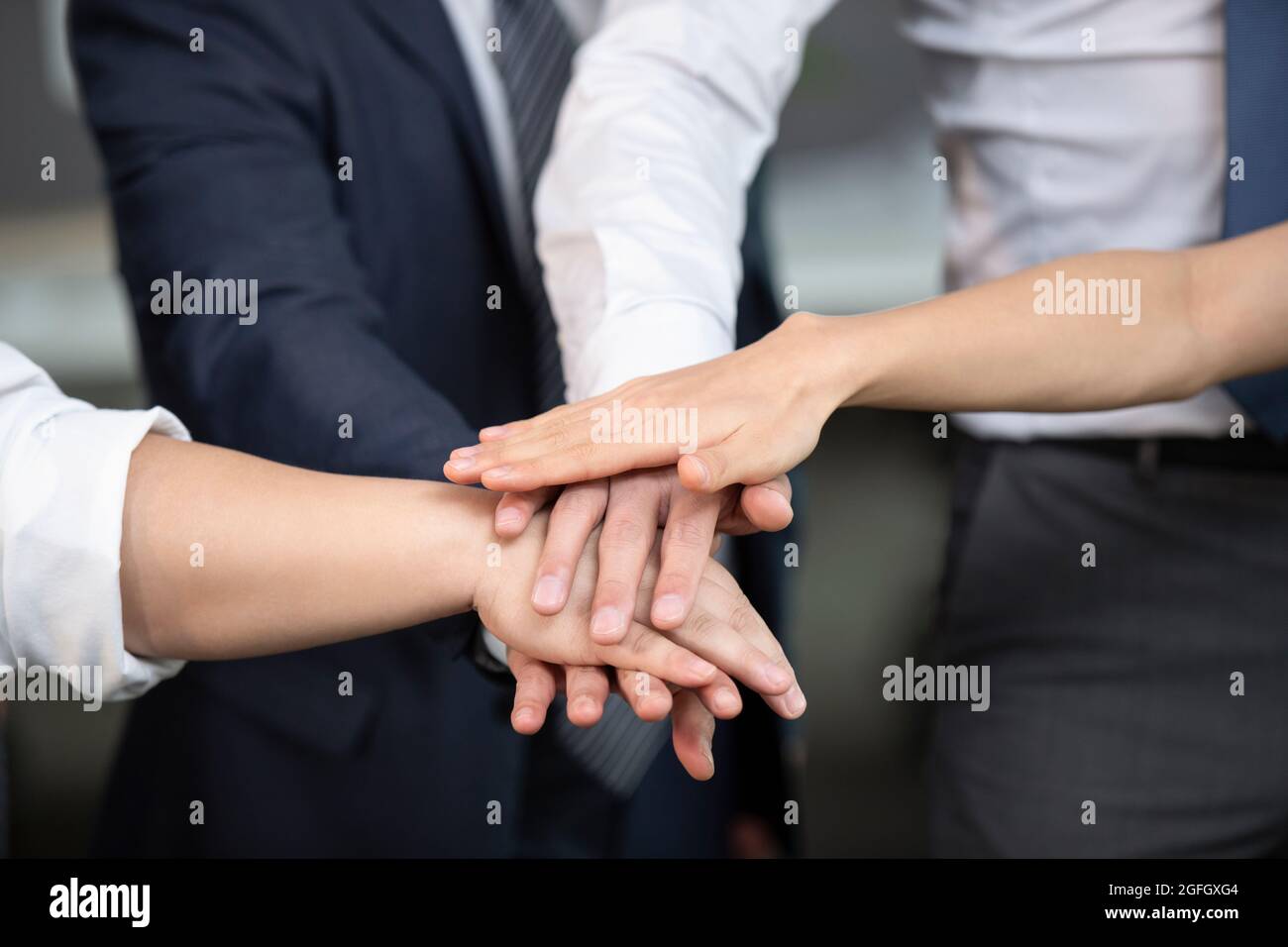 Business people stacking hands in office Stock Photo - Alamy