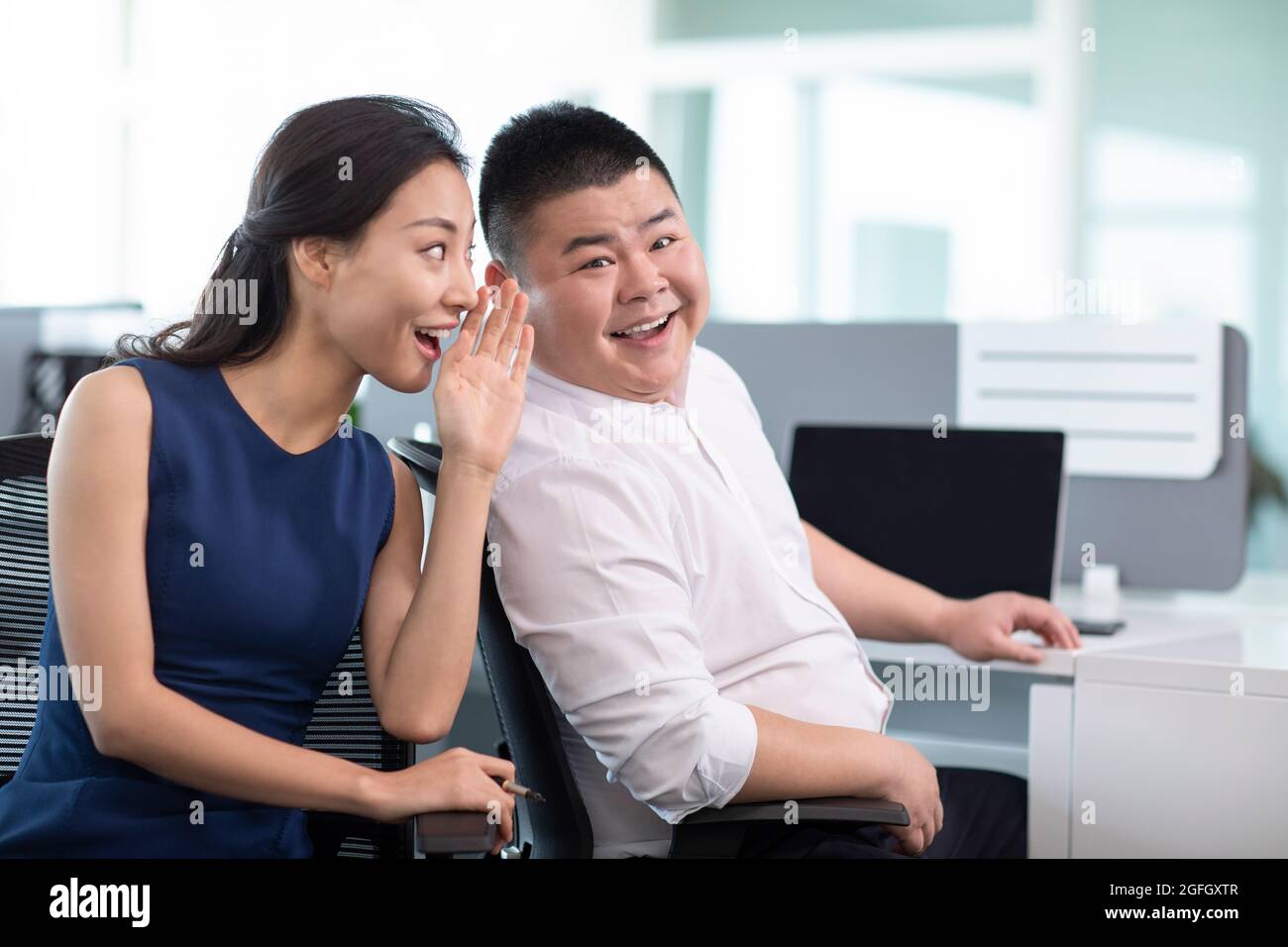 Business people talking gossip in office Stock Photo