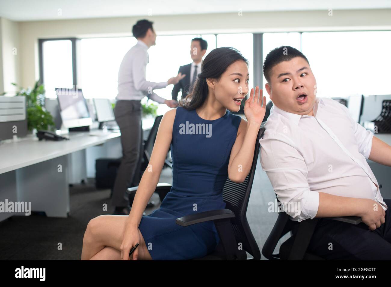 Business people talking gossip in office Stock Photo