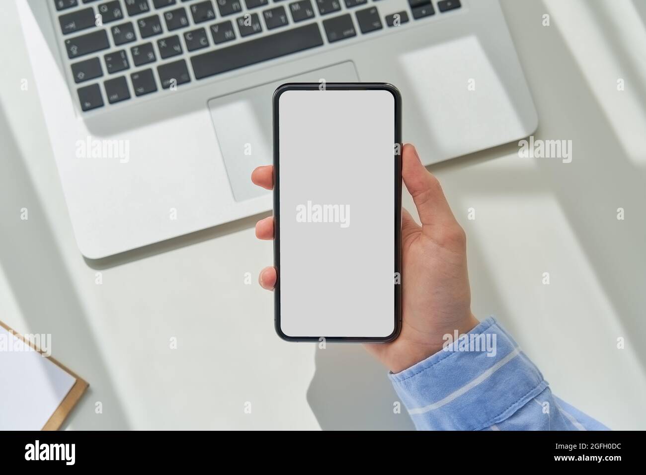 Faceless woman using smartphone with empty screen. Mockup, flat lay, copy space, template Stock Photo