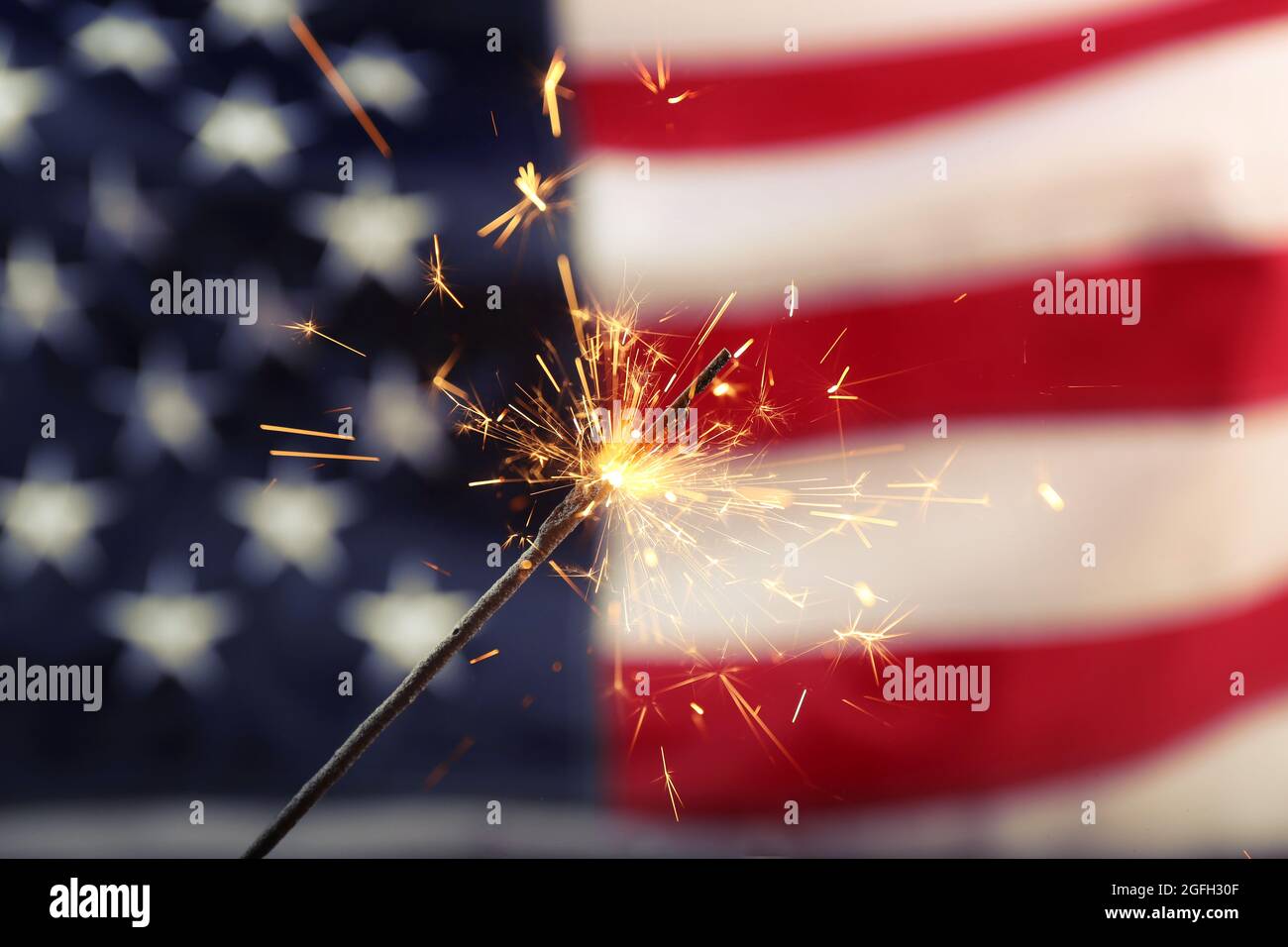 Sparkler on USA flag background Stock Photo - Alamy
