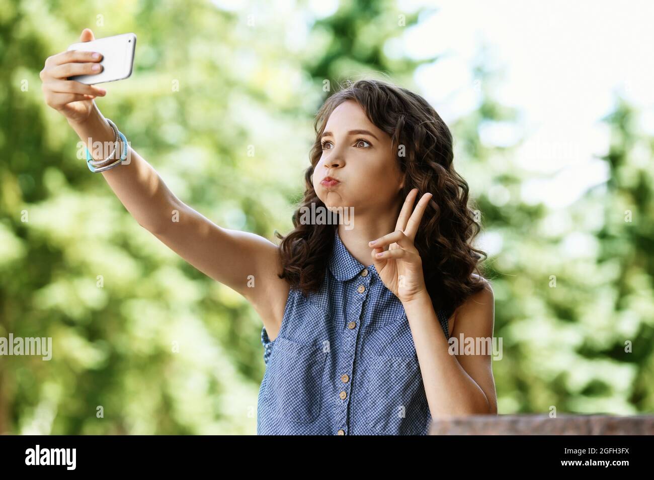 Beautiful young girl taking selfie outdoor Stock Photo - Alamy