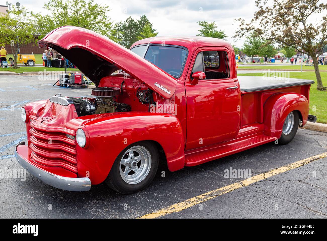 A classic red Chevrolet pick-up truck on display with the hood open at a car show in Angola, Indiana, USA. Stock Photo