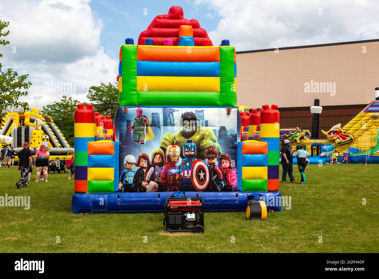 Marvel characters as Legos adorn the side of this inflatable bouncy house outside the Angola High School building in Angola, Indiana, USA. Stock Photo