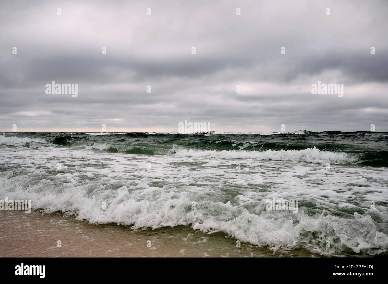 Waves in the Gulf of Mexico roll in or are rolling in on the beach during a storm near Destin Florida, USA. Stock Photo
