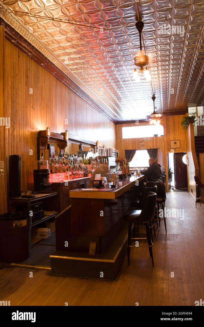 Classic tin ceiling tops bar in Montana John's Silver Mill Saloon, 'casual 1890s setting,' Philipsburg, MT. Stock Photo