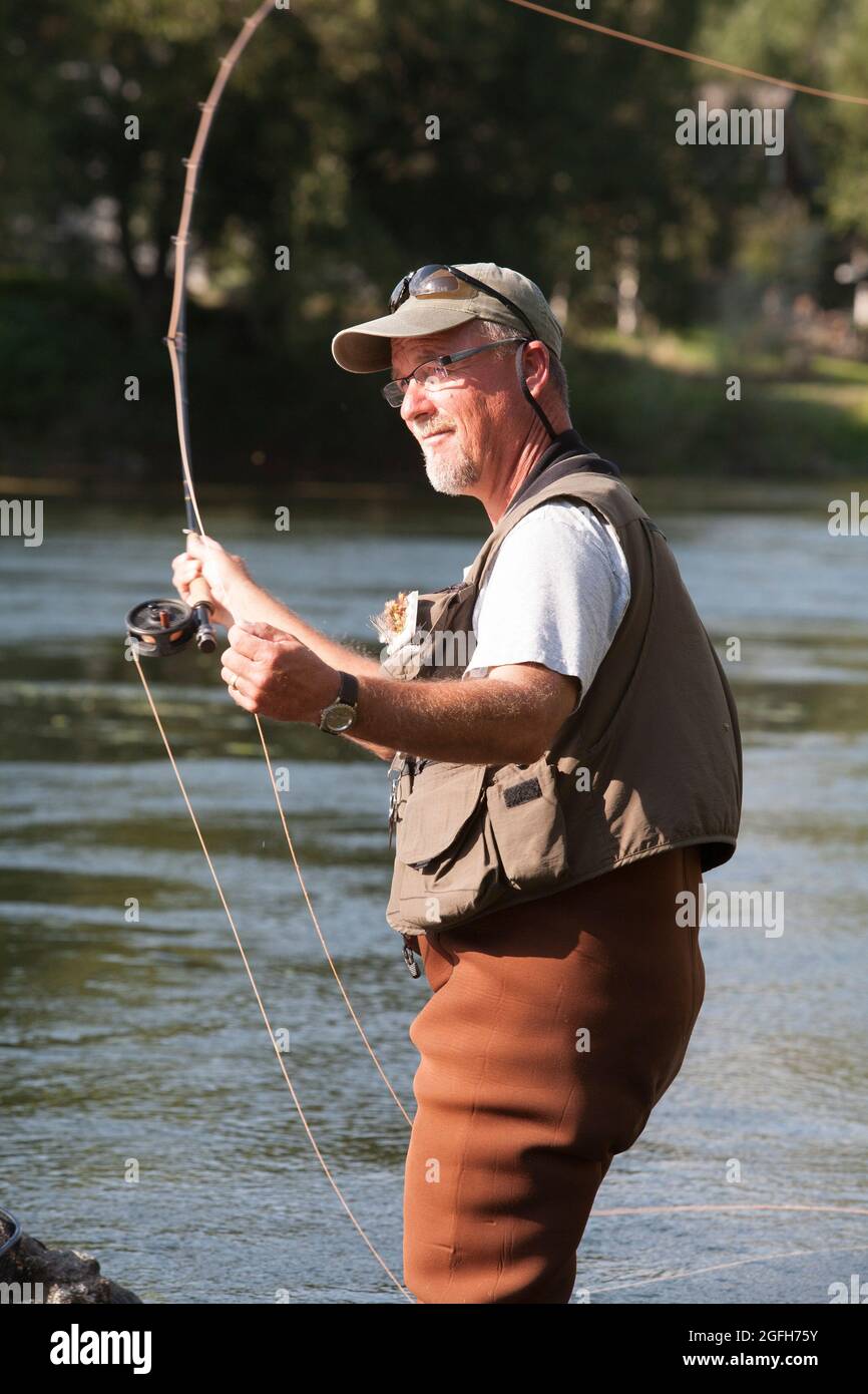 Fisherman casts for trout, fly fishing the Missouri River. (MR Stock