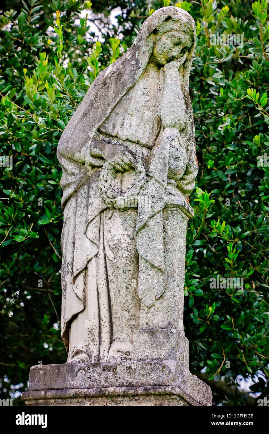 A cemetery angel stands over a grave at Magnolia Cemetery, Aug. 14, 2021, in Mobile, Alabama. Stock Photo