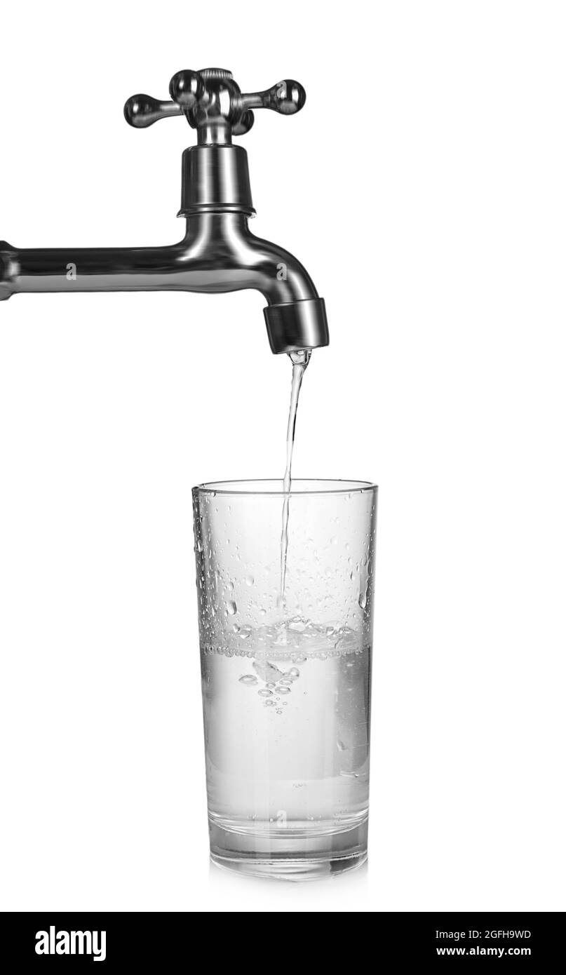 Metal tap with water dripping in glass isolated on white, saving water
