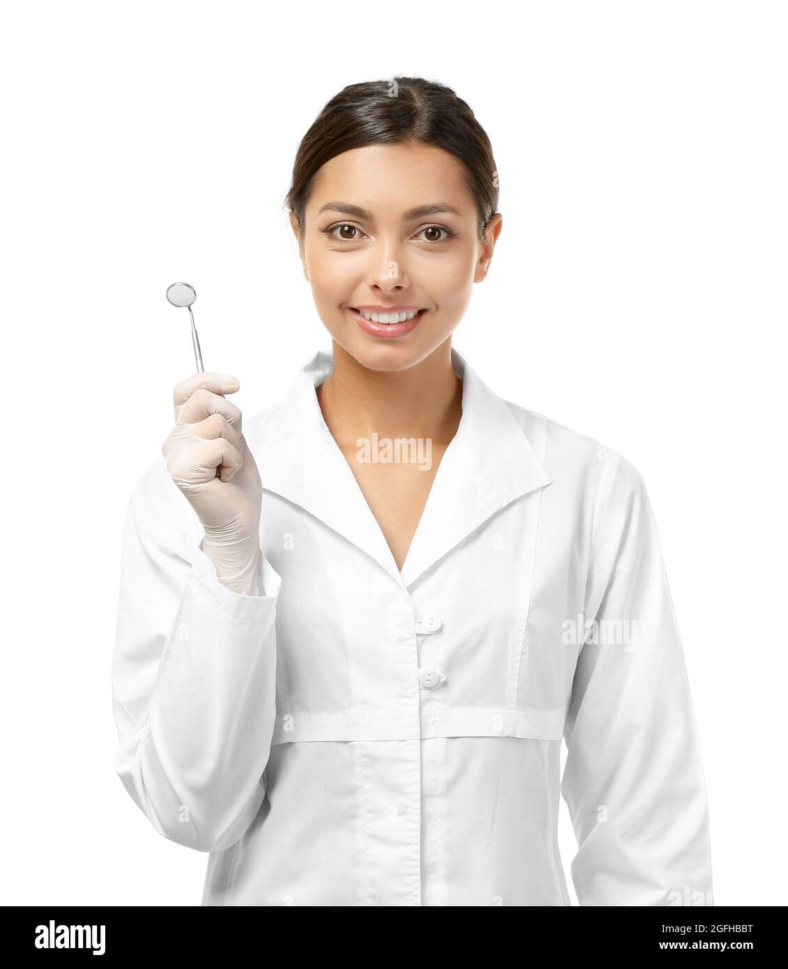 Young female dentist wearing in uniform and holding medical equipment isolated on white Stock