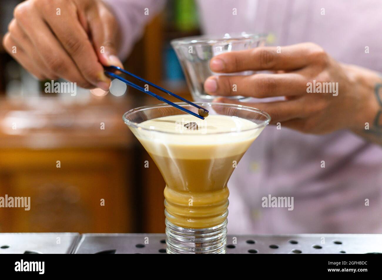 Barman decorating alcoholic drink called irish coffee Stock Photo Alamy