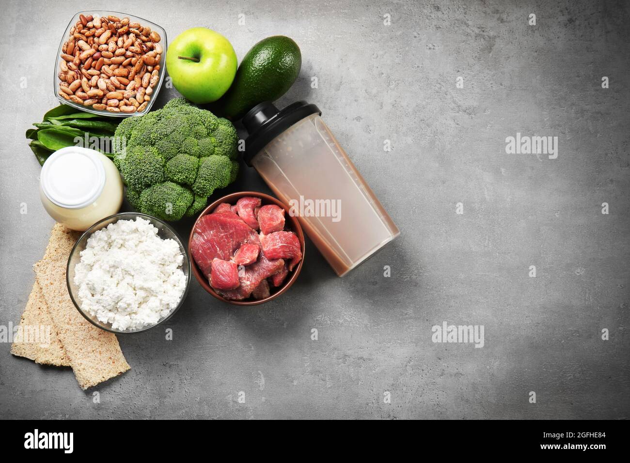 Food high in protein on grey background Stock Photo - Alamy