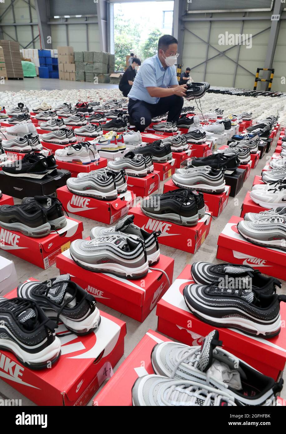 Korea. 26th Aug, 2021. 26th Aug, 2021. Fake designer sneakers seized in  Busan Customs officials display thousands of fake sneakers of Nike and  other foreign brands they have confiscated at a warehouse