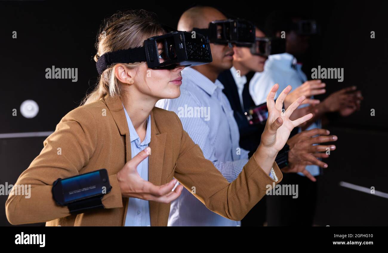 Woman using virtual reality headset and gesturing Stock Photo