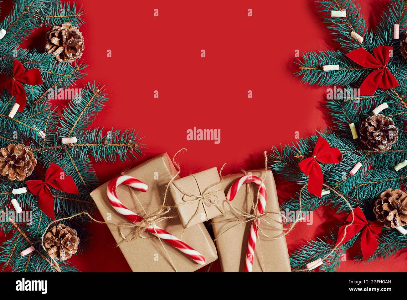 Christmas composition of pine cones, spruce branches and stack of gift ...