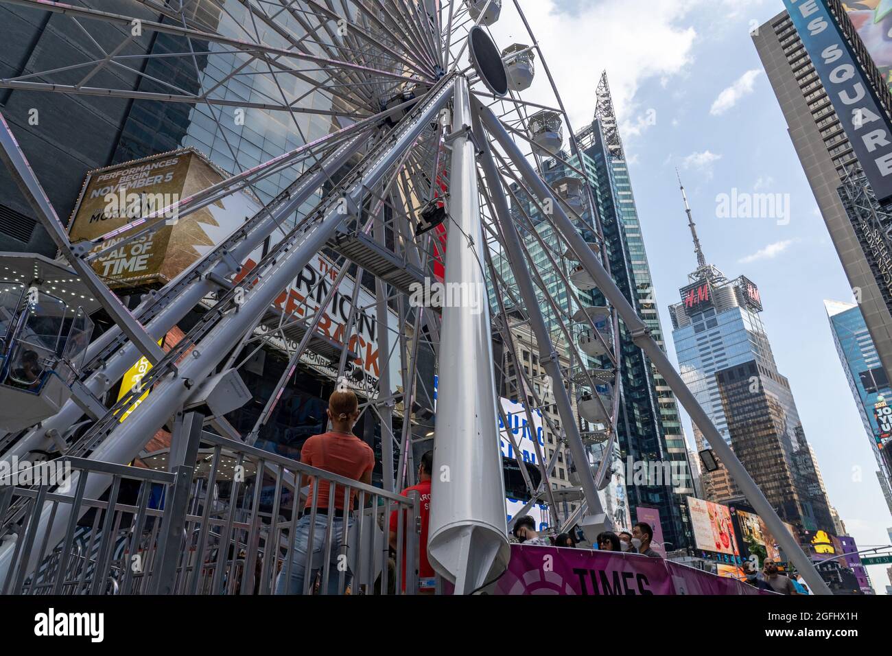 People ride the Times Square Ferris wheel on opening day in Times ...