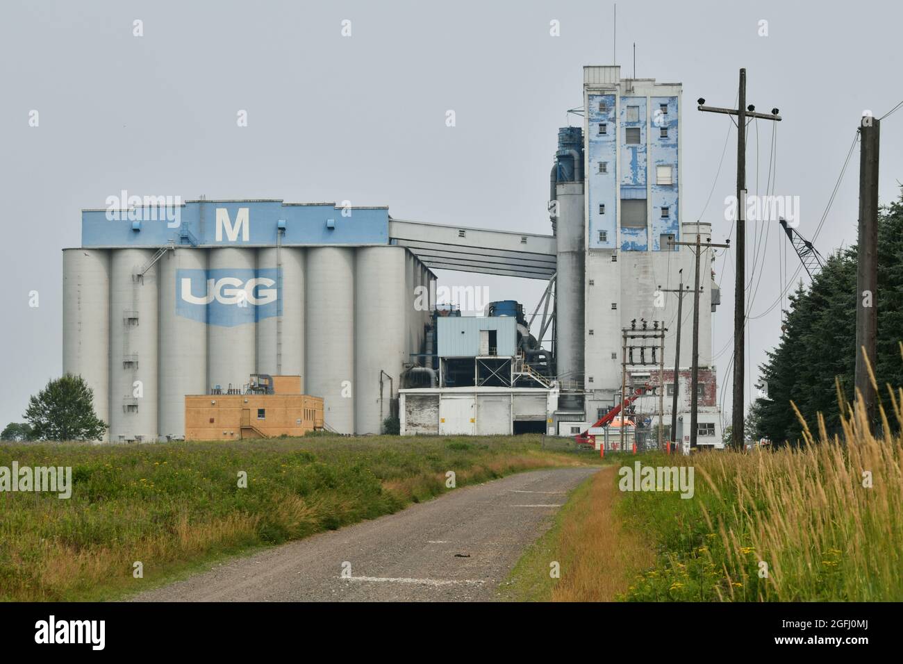 On a sunny, summer day  a road leads to elevators on Lake Superior in Thunder Bay, Ontario, Canada. Stock Photo