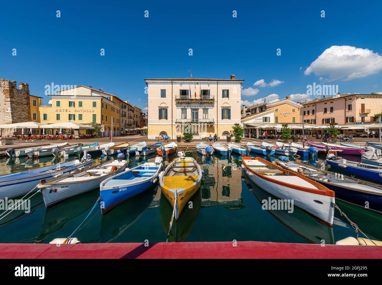 Port of the small village of Bardolino with fishing boats moored, tourist resort on the coast of Lake Garda (Lago di Garda). Verona, Italy. Stock Photo