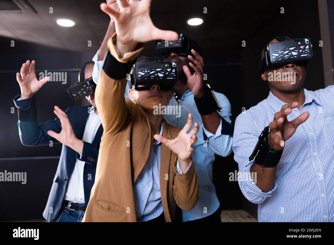 People using virtual reality headset and gesturing Stock Photo