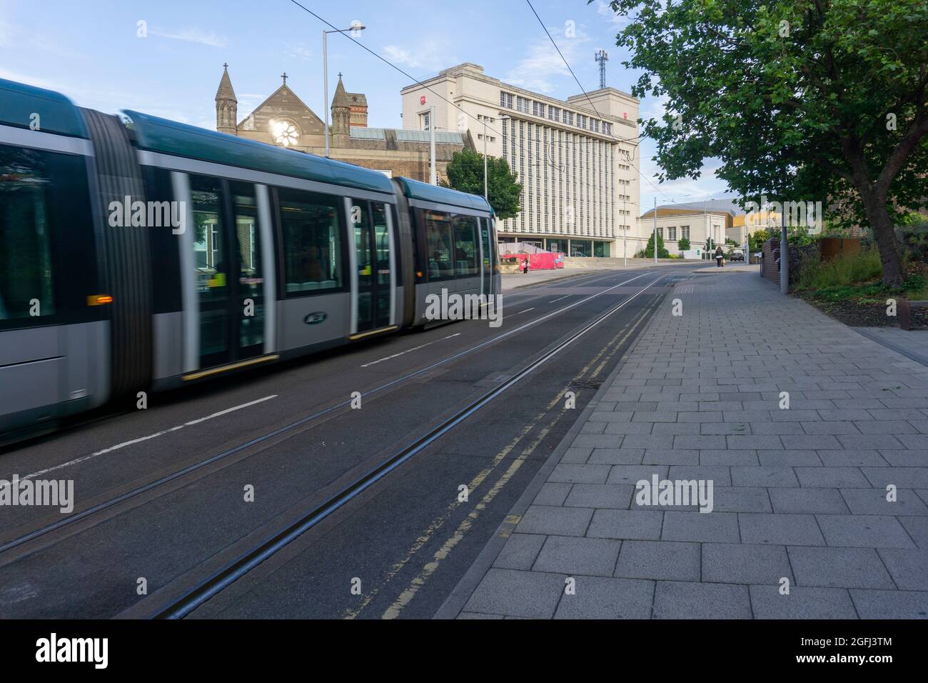 NET tram on Goldsmith Street about to pass Nottingham Trent University, Nottingham, East Midlands, UK Stock Photo