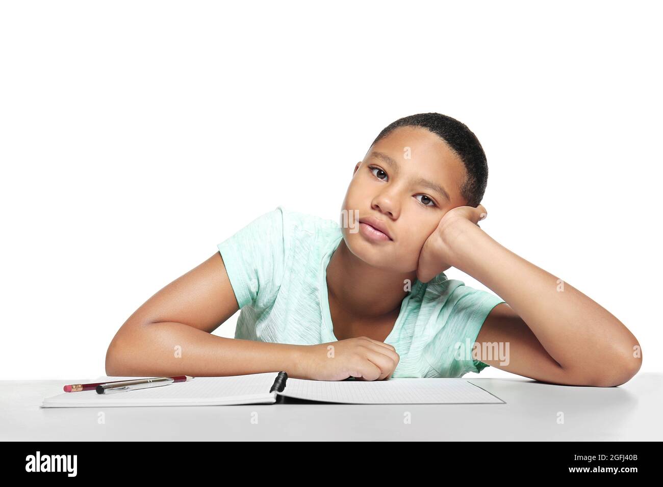 African American boy making homework on light background Stock Photo