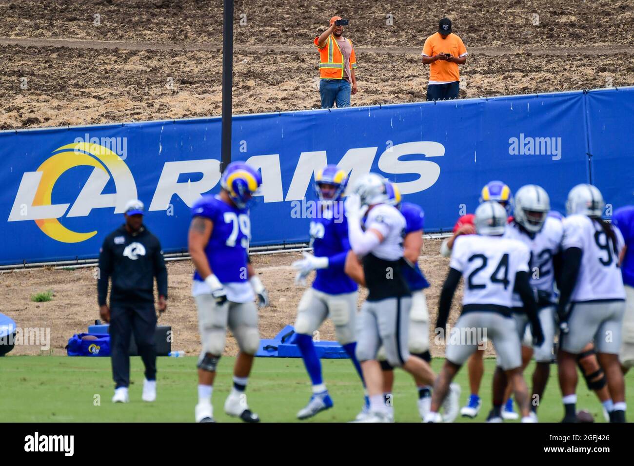 Fans observe a Las Angeles Rams and Las Vegas Raiders joint practice from a hillside on Wednesday, Aug 18, 2021, in Thousand Oaks, Calif. (Dylan Stewa Stock Photo