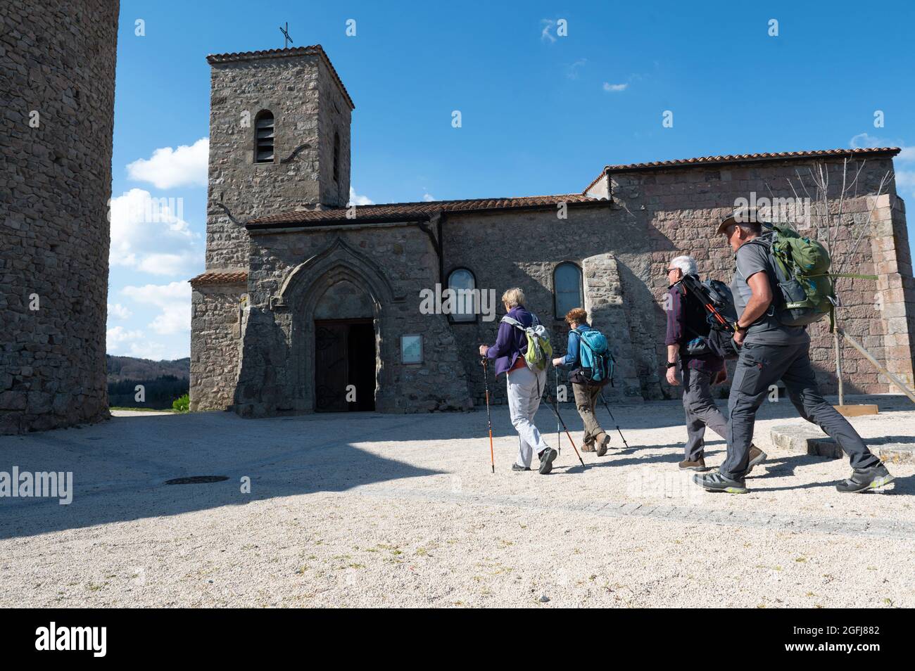 Couple of senior hikers in front of the Church of Boffres (south eastern France) Stock Photo
