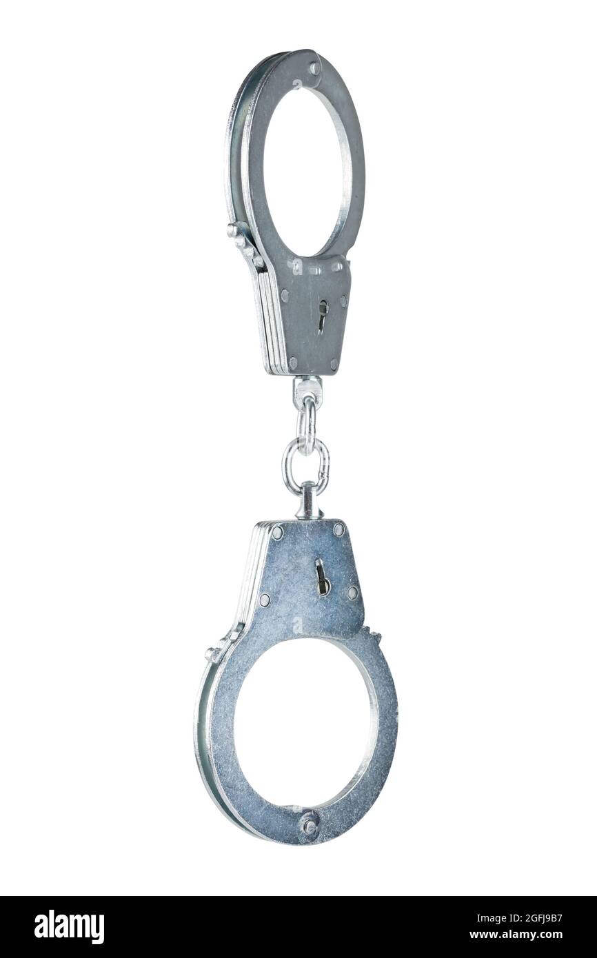 real zinc plated steel police handcuffs closed hanging vertically, isolated on white background Stock Photo