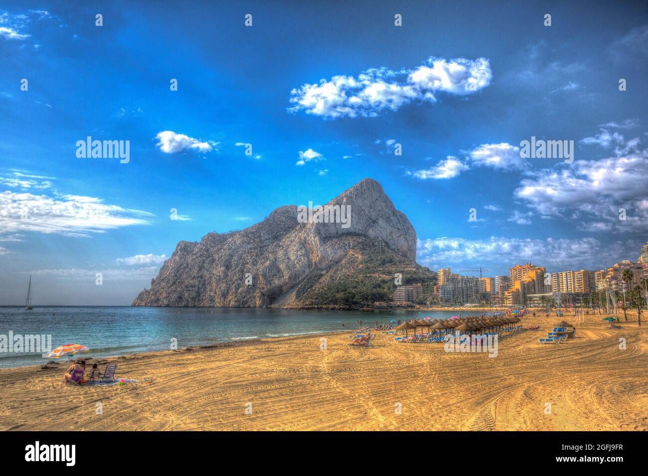 Calp rock Spain from Levante La Fossa beach Spain colourful HDR Stock Photo