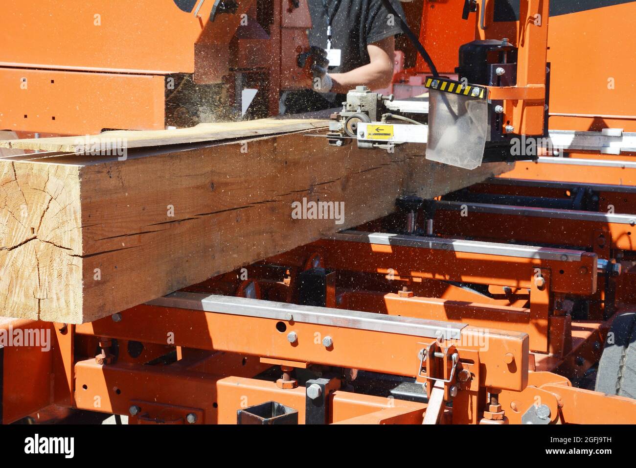 A closeup on a sawmill machine with modern equipment which is cutting