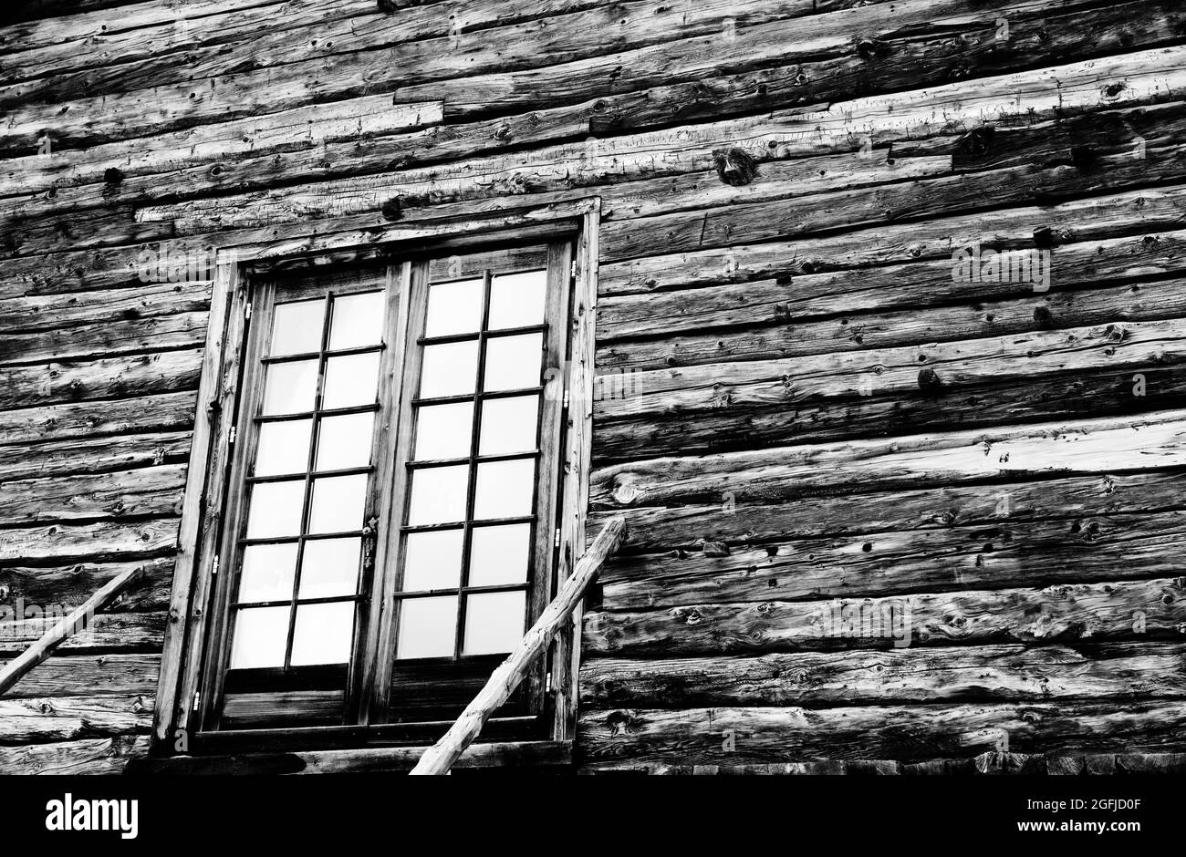 Wooden house with glazed front door and staircase with railing. Black and white toned image. High contrast. Stock Photo