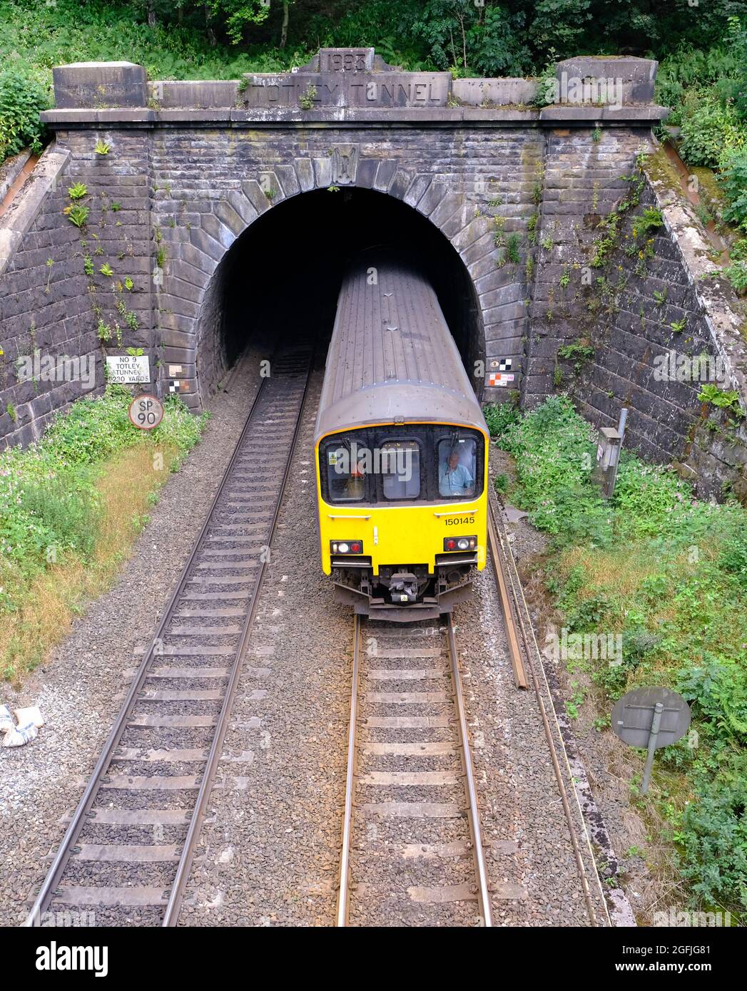 A train emerges from the 19th century Totley Tunnel, Grindleford, Derbyshire, the second longest