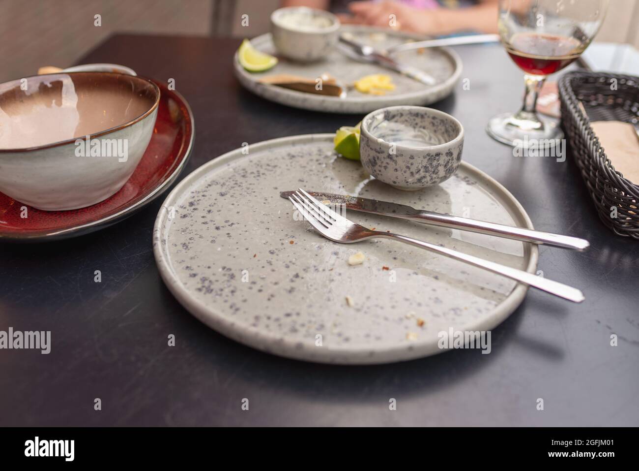Three empty plates after meal is finished, with forks and knives. dirty plates after dinner