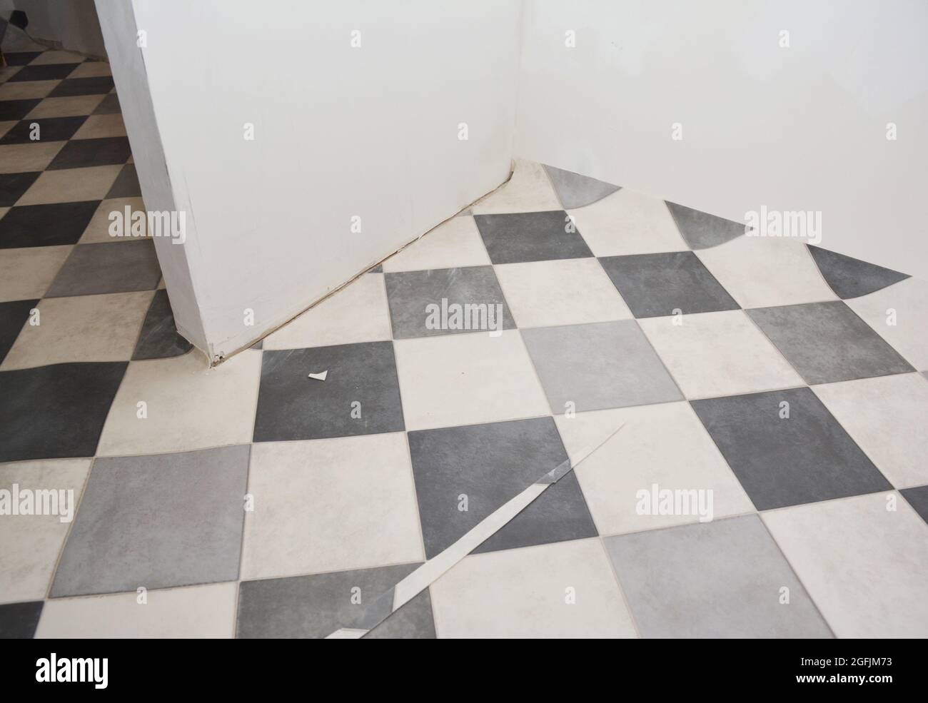Room renovation with linoleum flooring, black and white tile effect