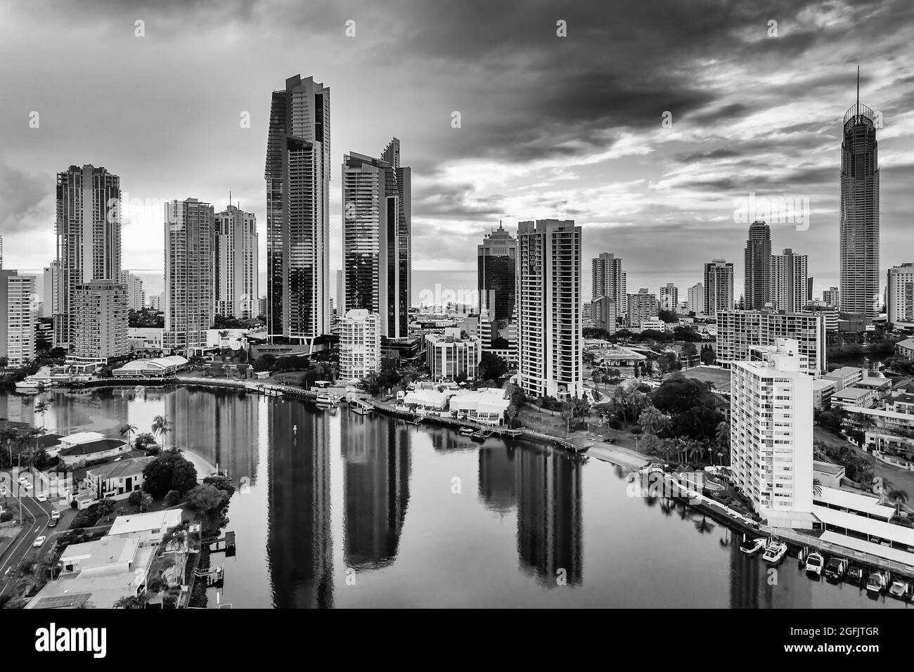 Cloudy black-whtie cityscape of high-rise towers in Surfers paradise city of Australian Gold Coast - aerial view to Pacific ocean from Nerang river. Stock Photo