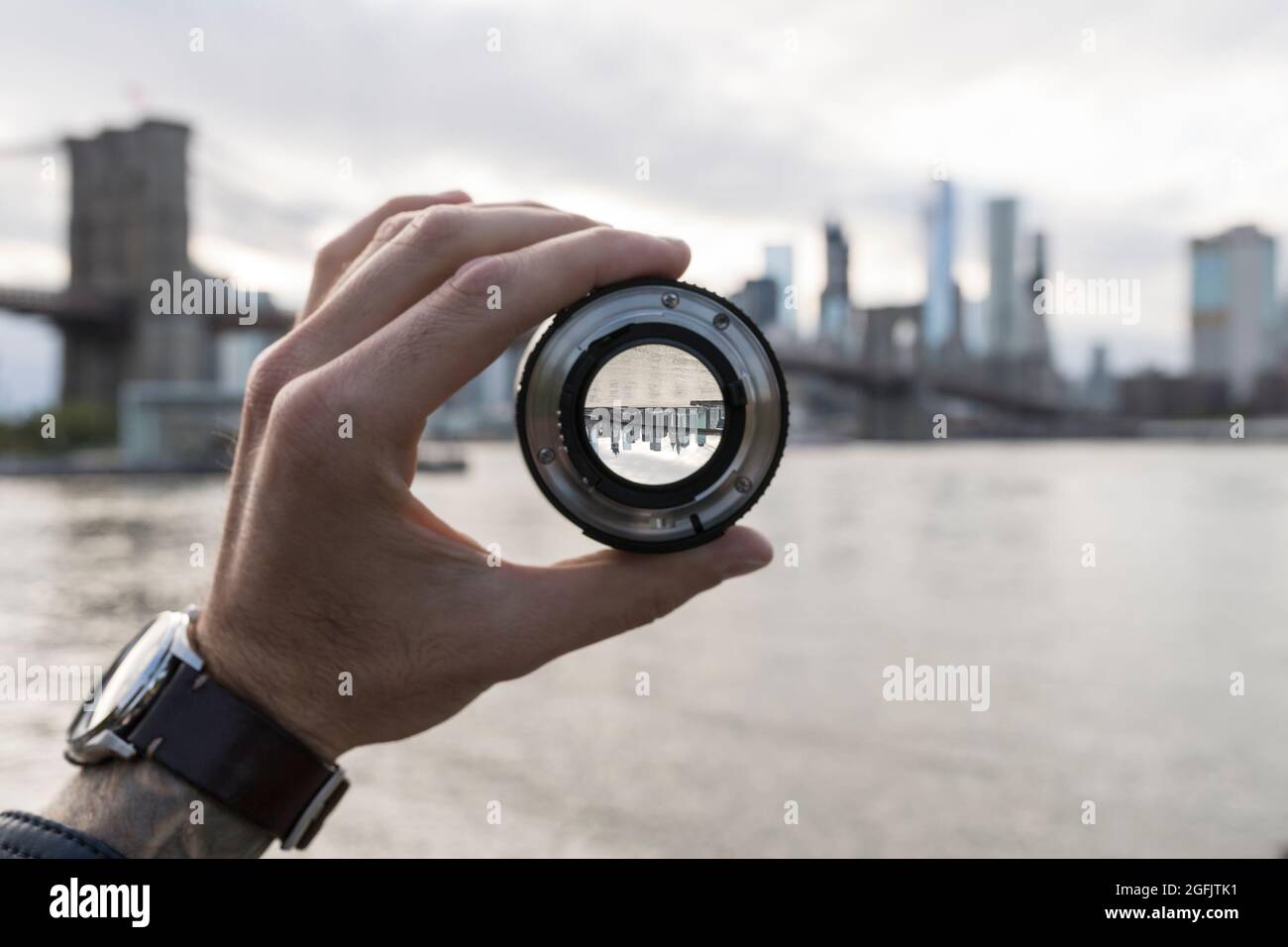 Hand holding a lens against New York City skyline Stock Photo - Alamy