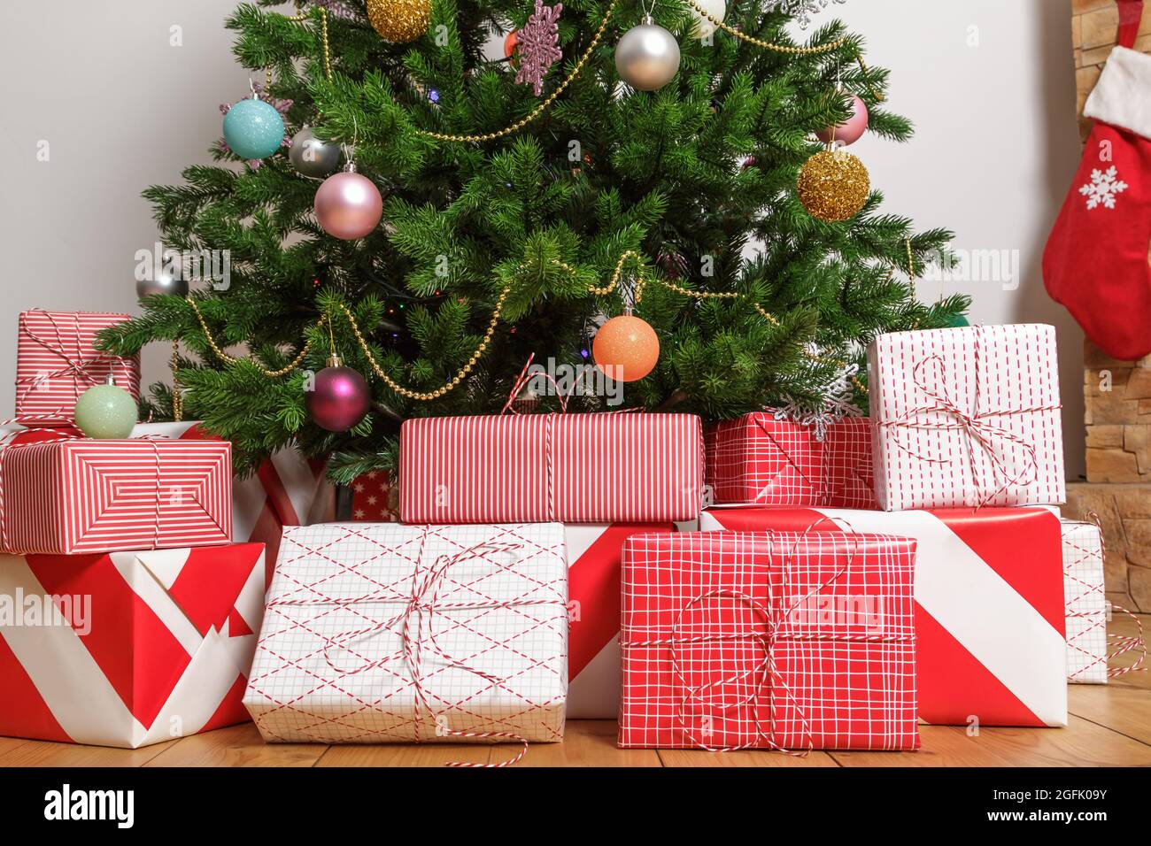 Close-up of christmas gift boxes under a tree Stock Photo
