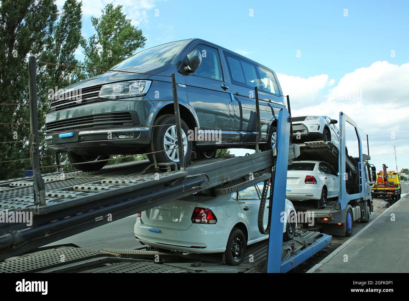 New cars on transporter truck Stock Photo - Alamy