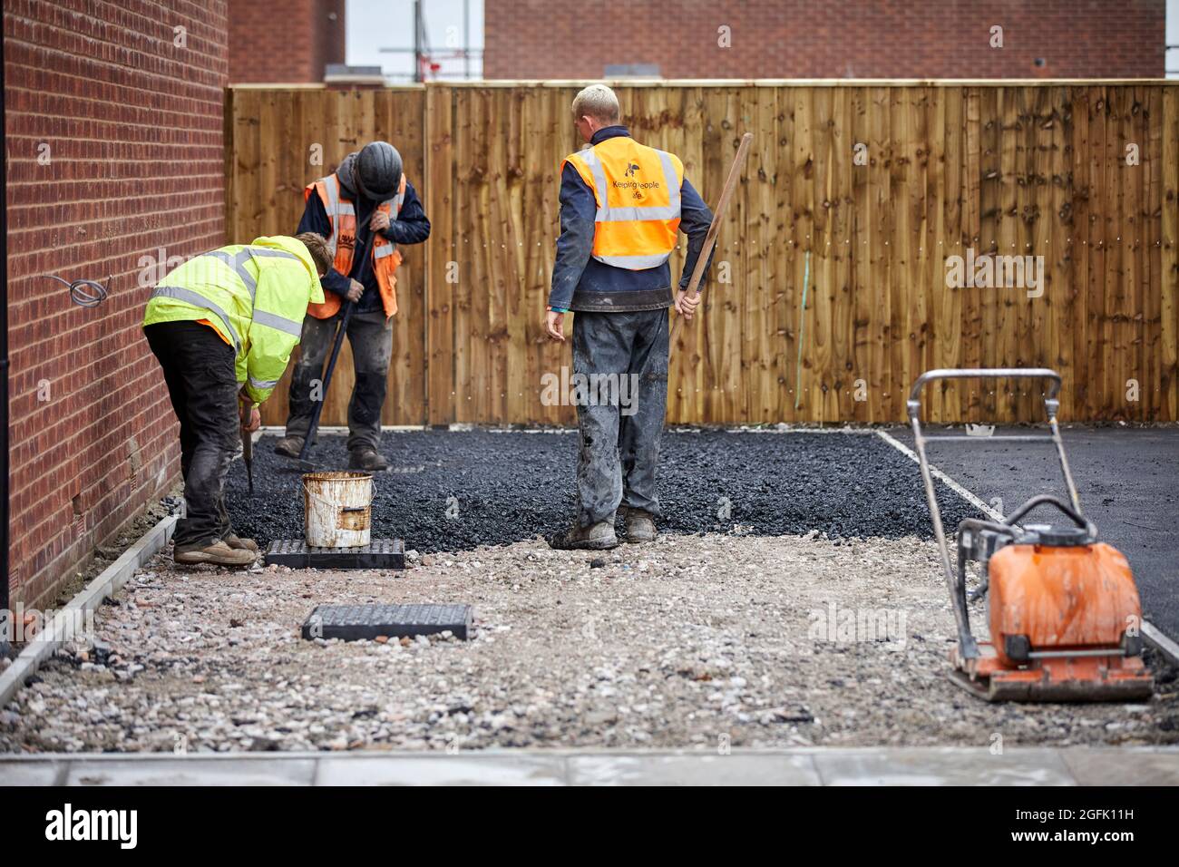 Tarmac drive laying at a building site of new houses in Formby Stock