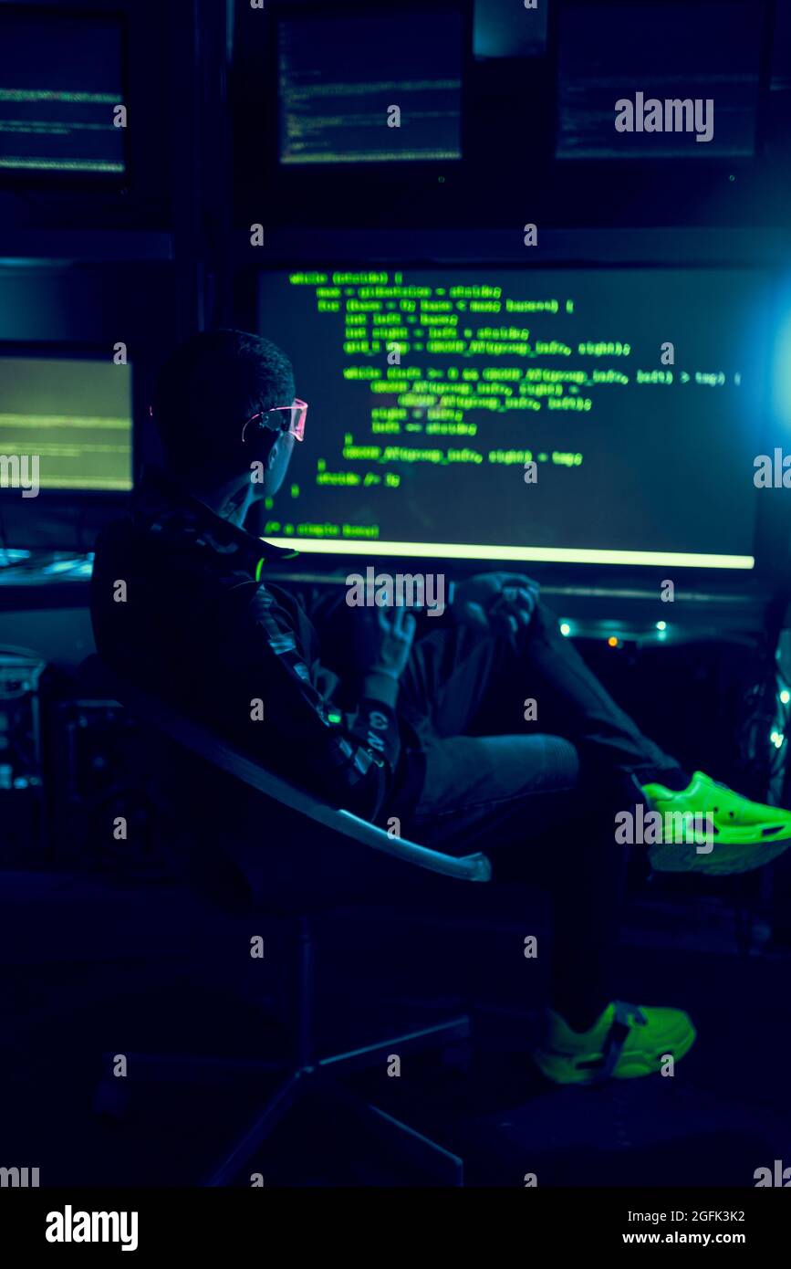 Cyber hacker breaks into databases to obtain information using a computer. Cybercrime and data security concept. Stock Photo