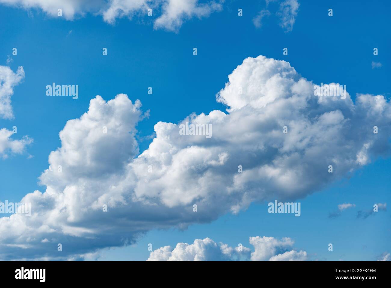 Small clouds on the blue sky. Cloudscape at day time. Stock Photo