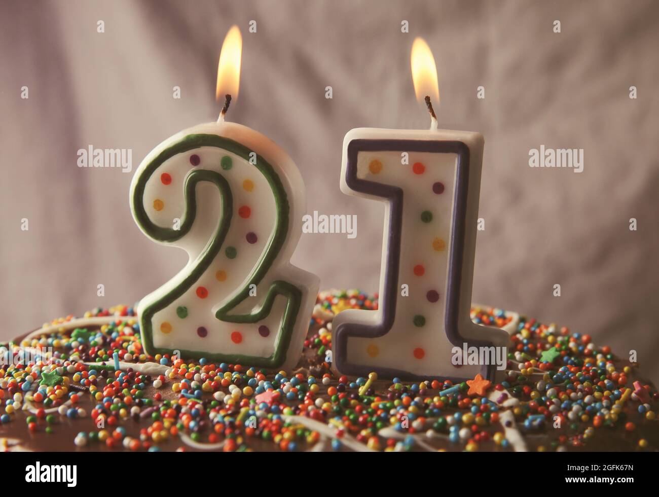 Birthday cake with burning candles on grey background Stock Photo - Alamy