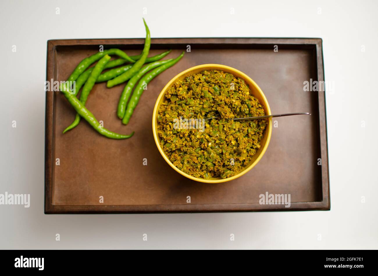 Raw Green Chilli pickle, Mirchi Achar placed on a wooden Tray. Top Angle View,  Studio Shot Stock Photo